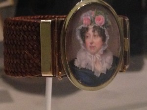 A mourning brooch, a miniature of the deceased with a cuff woven of her hair.